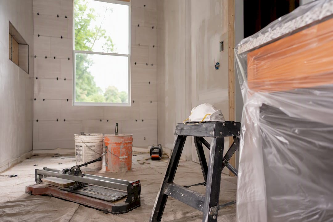 Bathroom remodel scene with tools and tiling