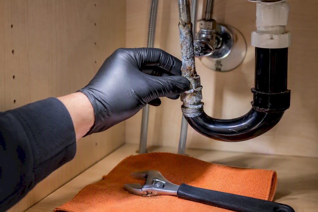 Corroded galvanized pipe under bathroom sink